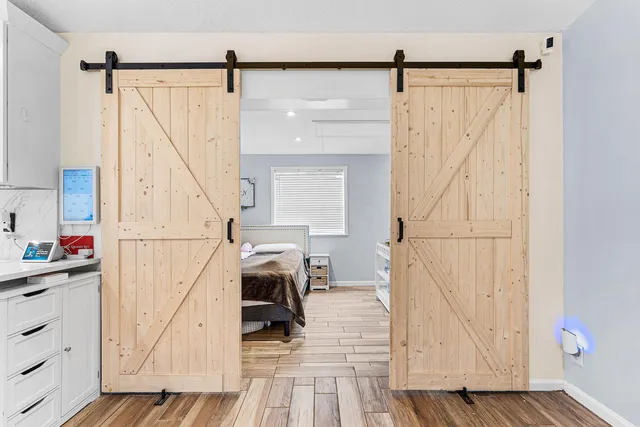 a view of living room with furniture and wooden floor
