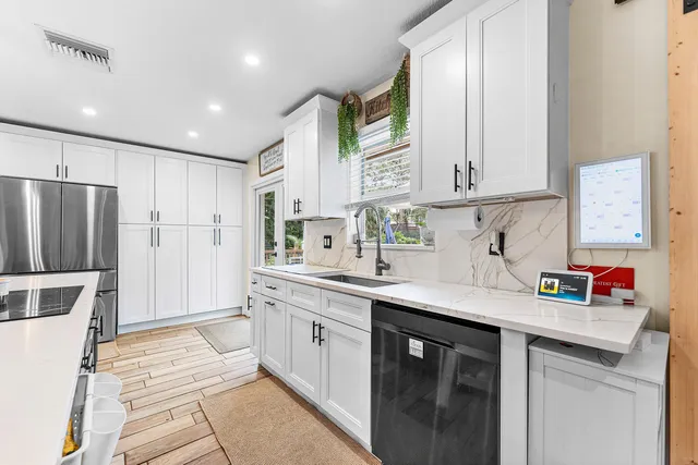 a kitchen with a sink cabinets and refrigerator