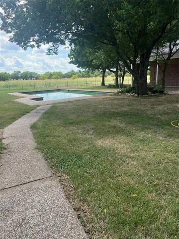 a view of a field with an trees