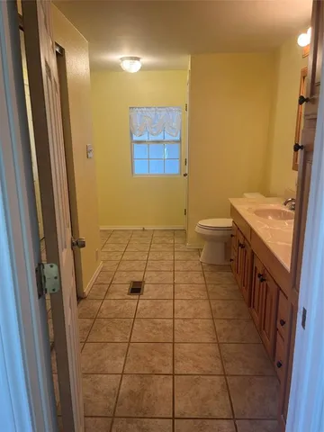 a bathroom with a sink a toilet a mirror and a shower