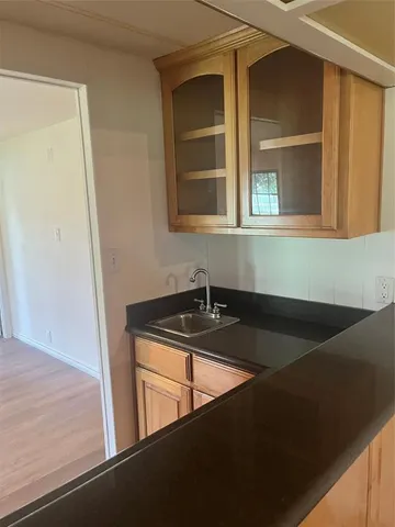 a room with a sink and cabinets