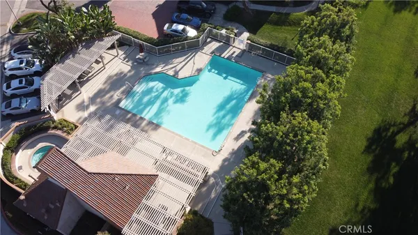 a aerial view of a house with a garden and mountains