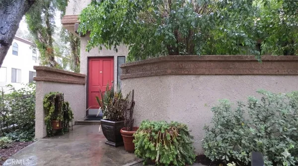a couple of flower plants in front of house