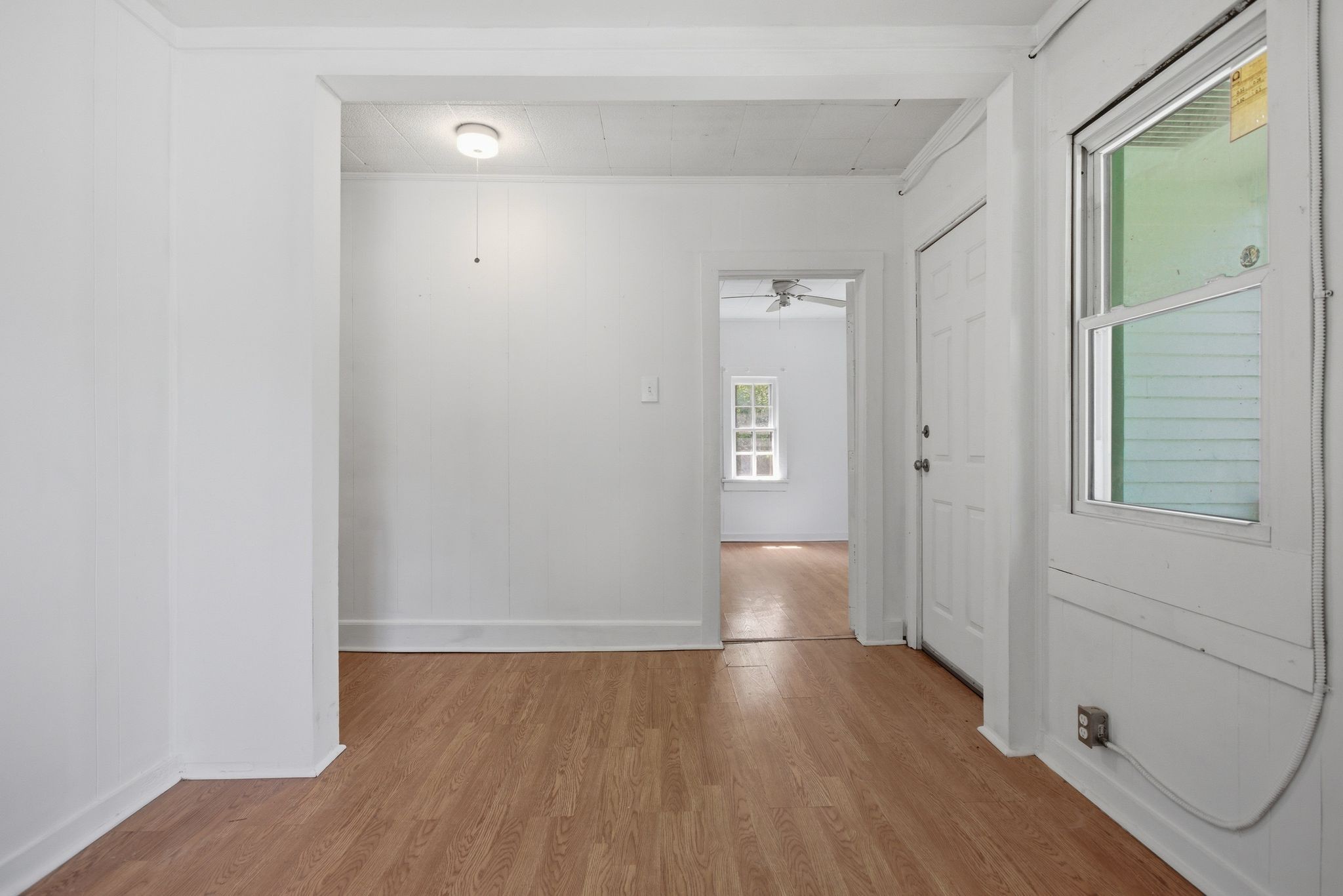 433 Jones Street Pulaski, TN 38478 - Photo 11 of 25 an empty room with wooden floor and windows