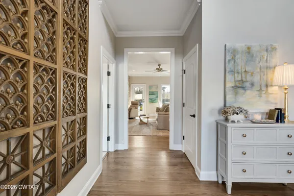 a view of a hallway view with wooden floor and living room