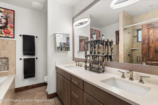 a bathroom with a double vanity sink and a mirror
