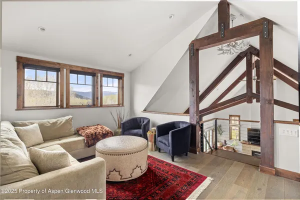 a living room with furniture a rug and a window