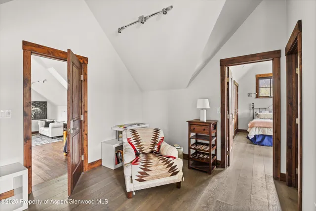 a bedroom with furniture and a large window