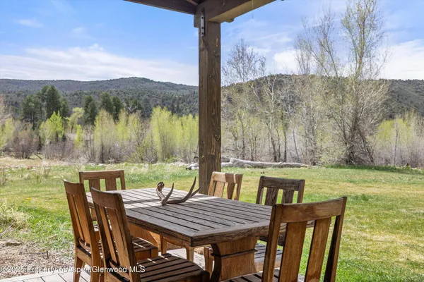 a view of a chairs and table in patio