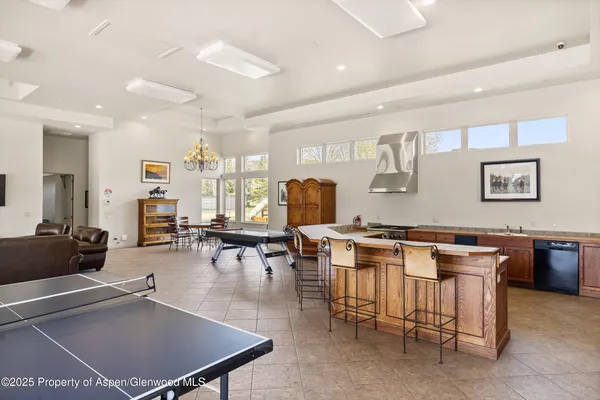 a living room with furniture a flat screen tv and a table