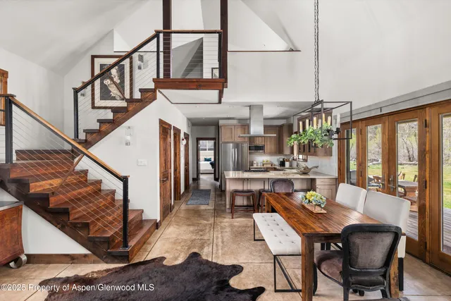 a dining room with furniture window and wooden floor