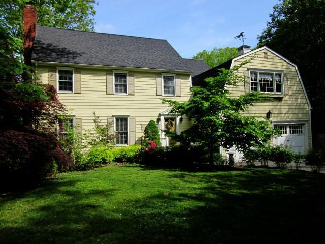 22 Strawberry Ridge Road Ridgefield, CT 06877 - Photo 1 of 1 a front view of a house with a garden