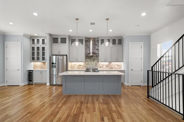 a view of kitchen with stainless steel appliances granite countertop stove top oven and cabinets