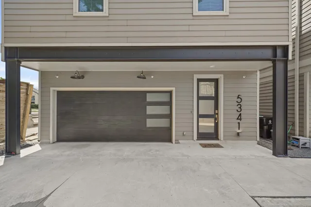 an empty room with a window and a ceiling fan