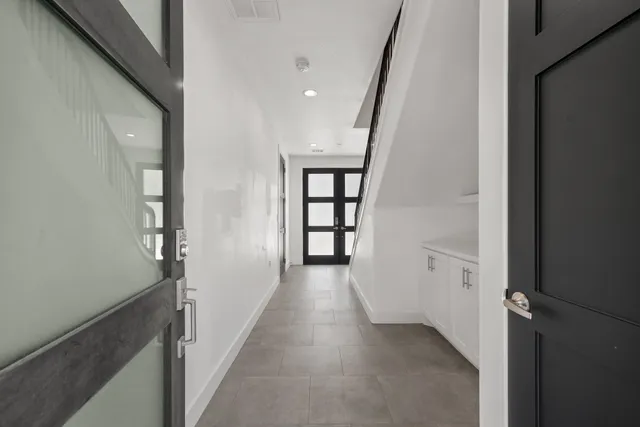 a view of an entryway with wooden floor