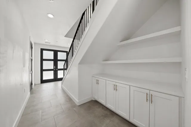 a view of a hallway with wooden floor and entryway
