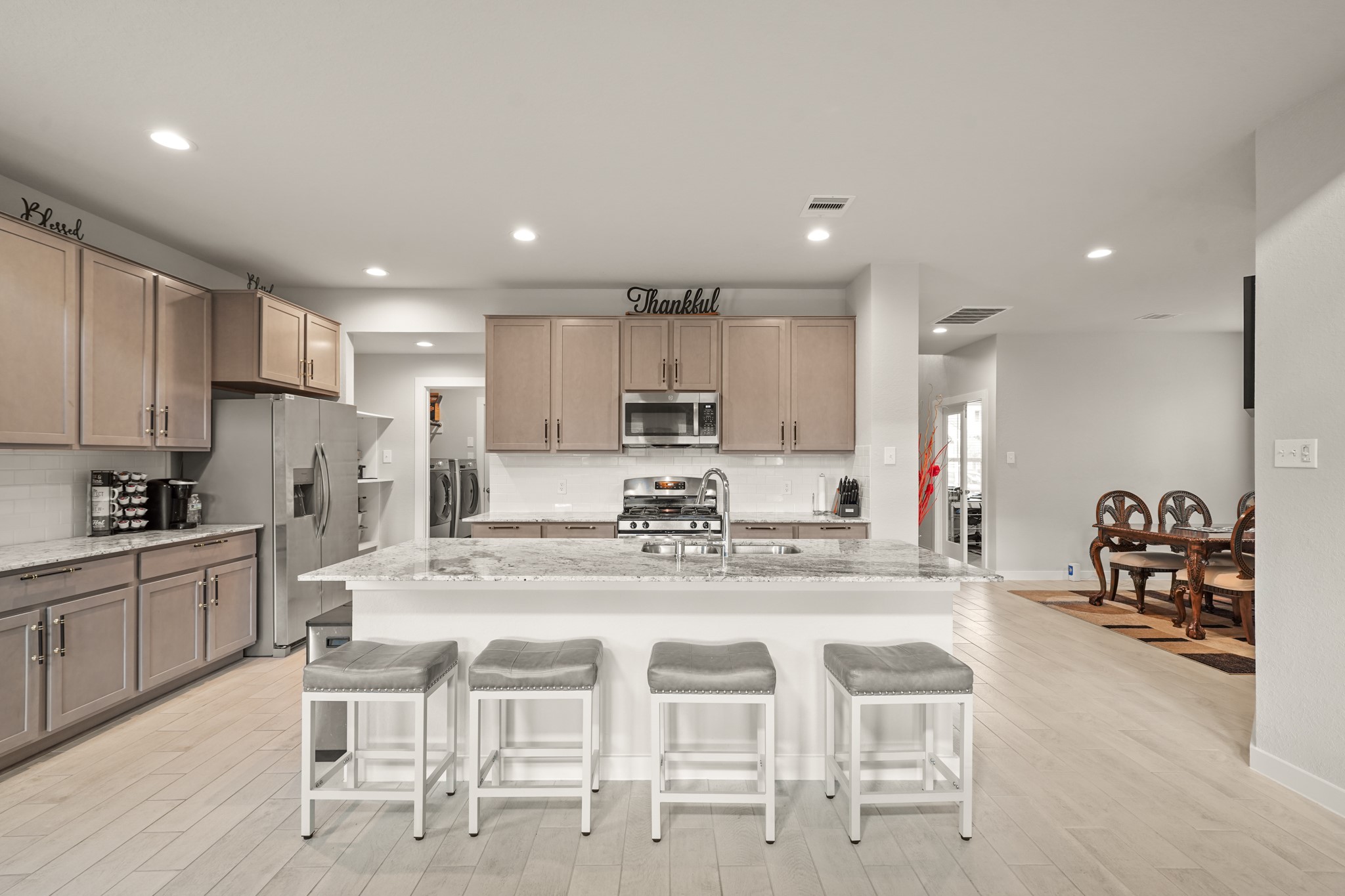 18419 Windy Knl Way Houston, TX 77084 - Photo 32 of 50 a kitchen with kitchen island granite countertop wooden cabinets and stainless steel appliances
