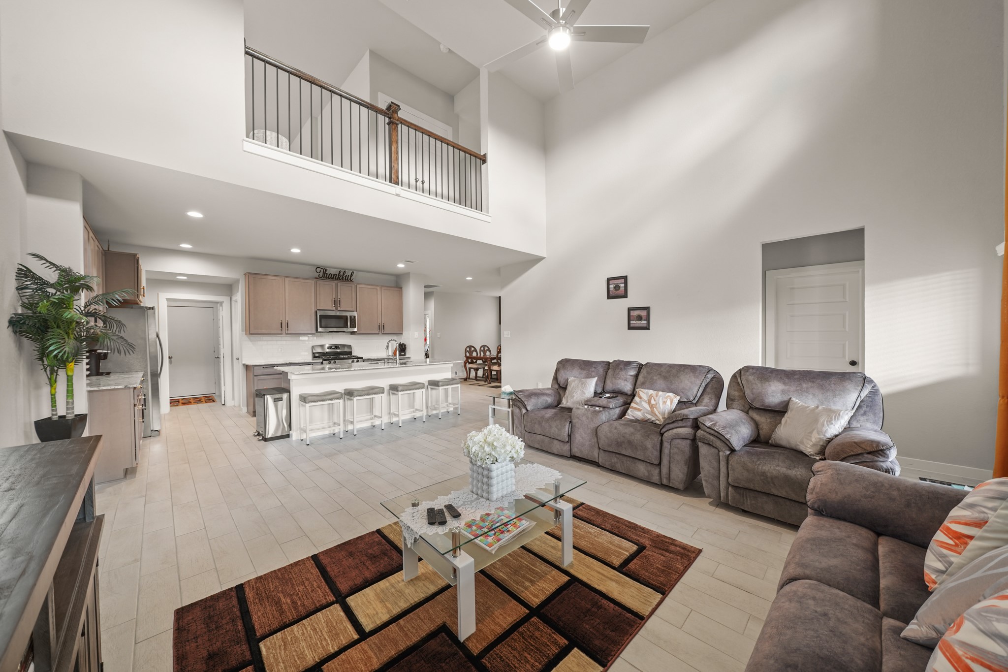 18419 Windy Knl Way Houston, TX 77084 - Photo 33 of 50 a living room with furniture and a dining table with kitchen view