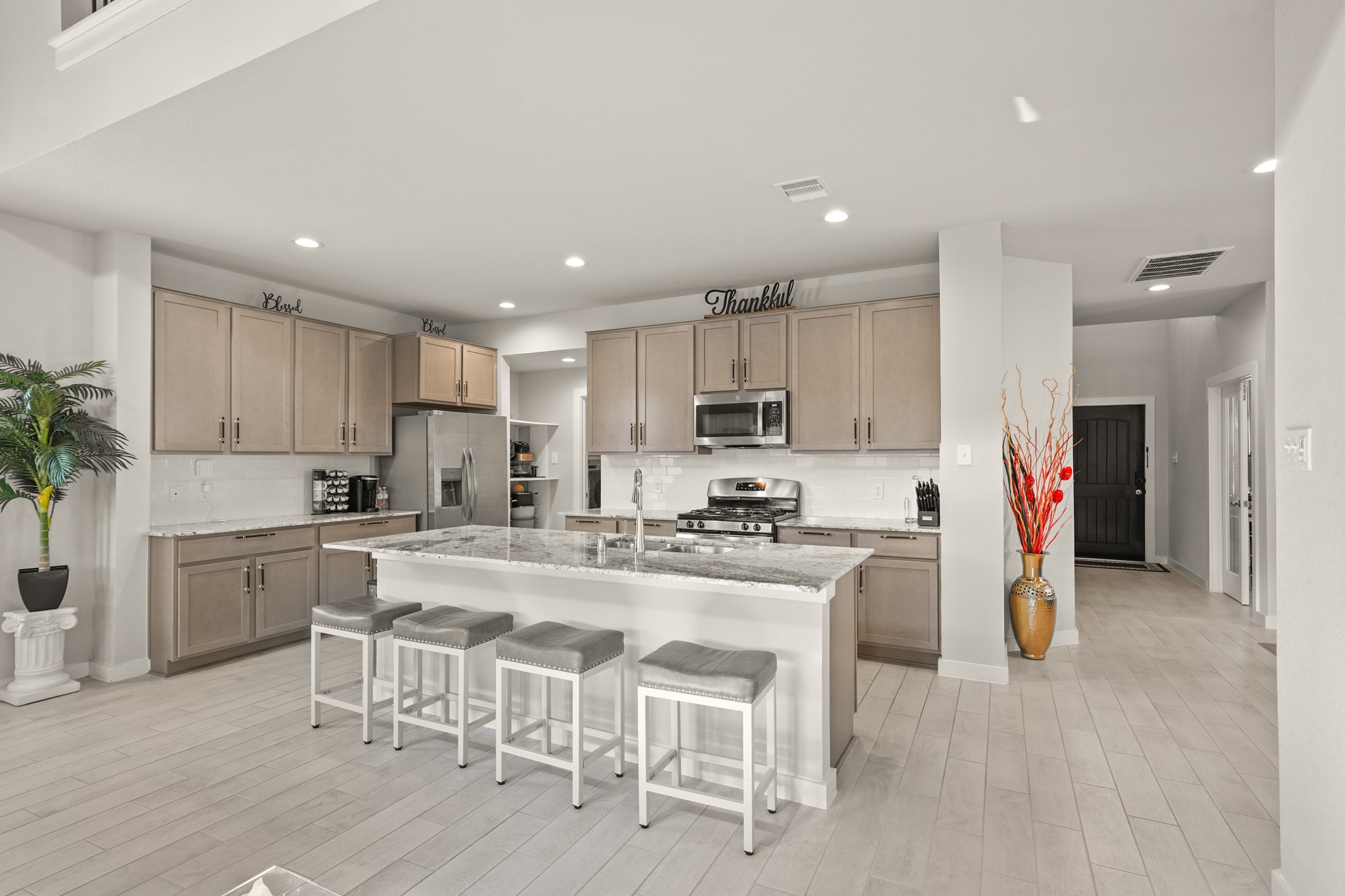 18419 Windy Knl Way Houston, TX 77084 - Photo 6 of 50 a kitchen with stainless steel appliances granite countertop a stove refrigerator and cabinets