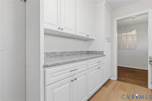 a view white cabinets and granite counter top