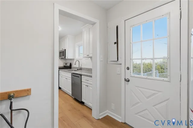 a kitchen with a refrigerator and a sink