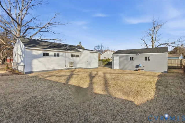 a view of a white house with a snow on the road