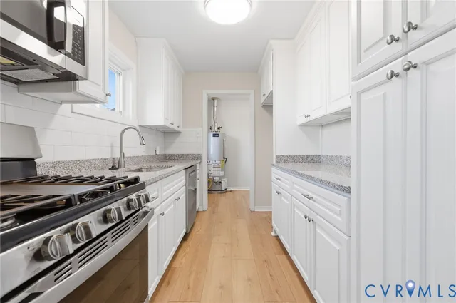 a kitchen with stainless steel appliances a stove and a refrigerator