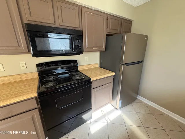 a kitchen with appliances and cabinets