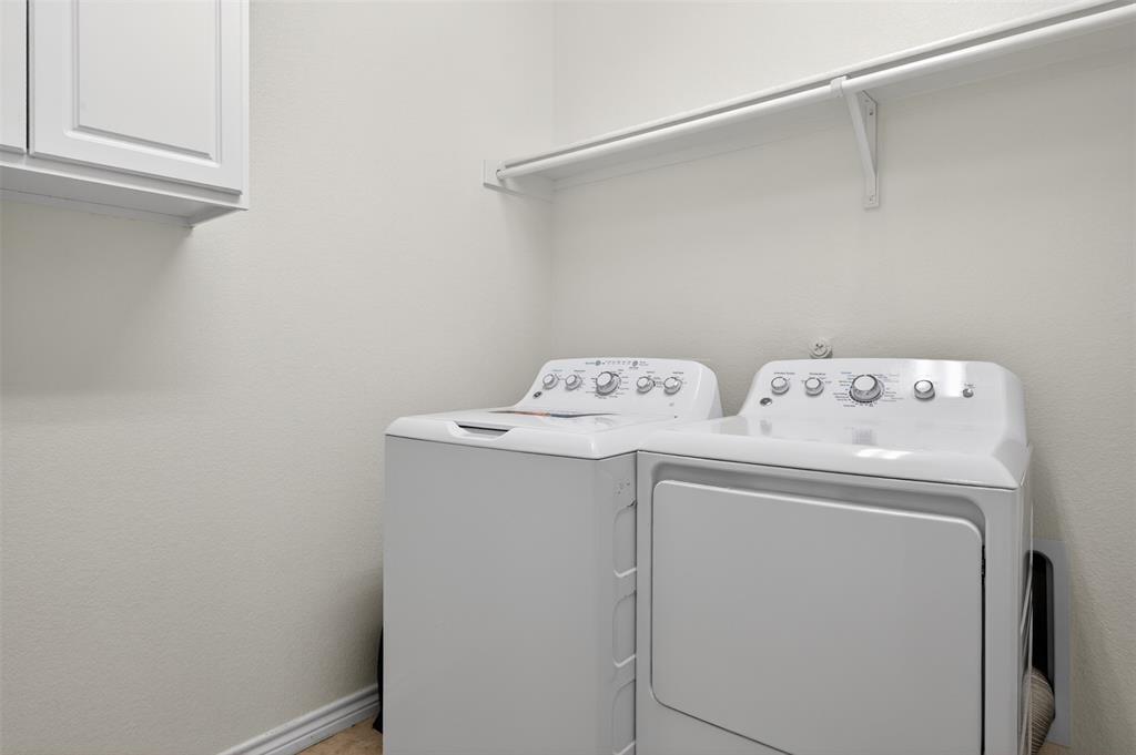 8728 Maple Ridge Trail Fort Worth, TX 76244 - Photo 37 of 40 Laundry area featuring a built-in shelf and overhead cabinetry