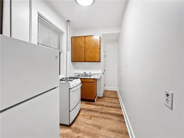 a kitchen with a stove top oven and sink