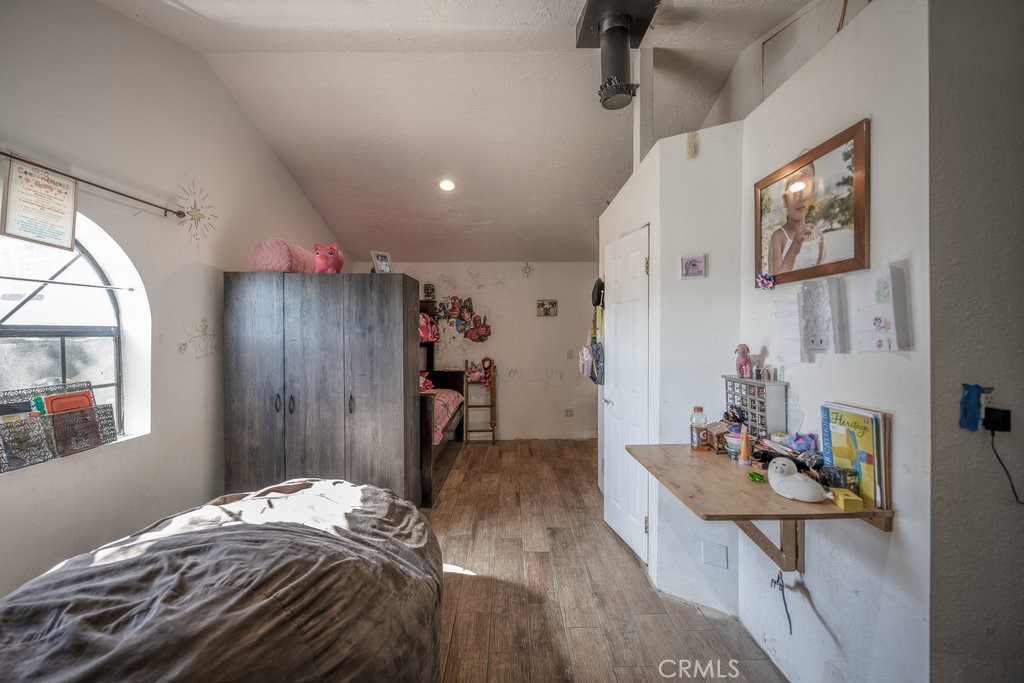9555 1/2 Hierba Road Agua Dulce, CA 91390 - Photo 15 of 26 a bedroom with a bed and wooden floor