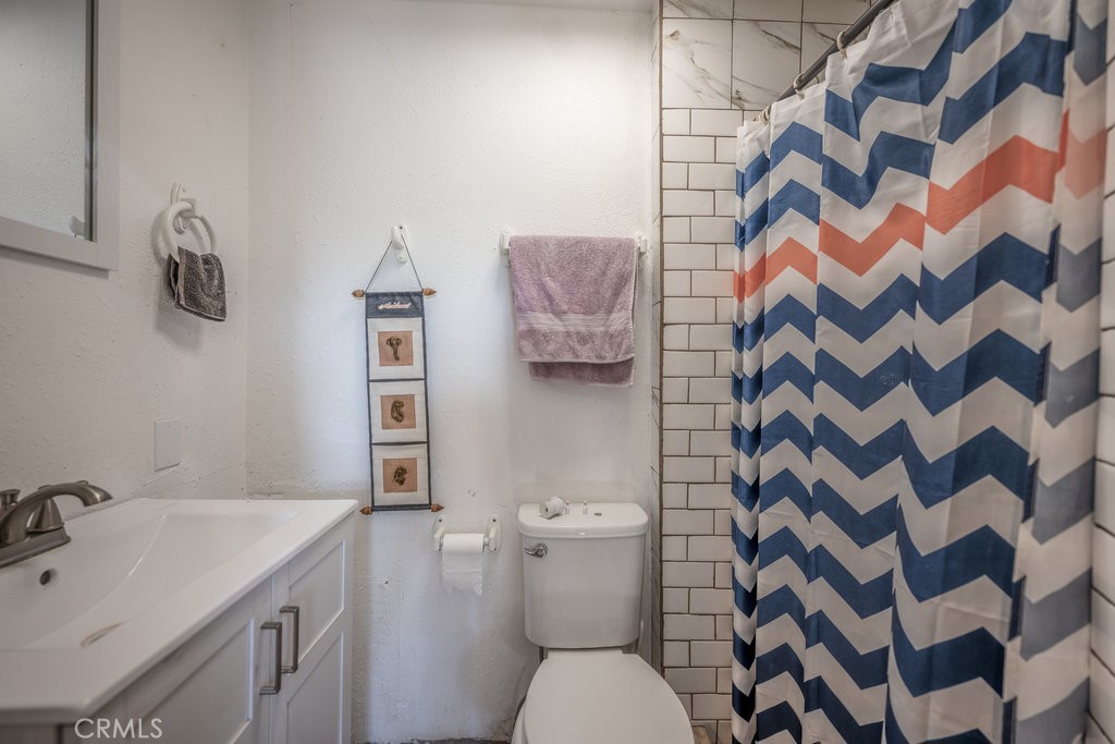 9555 1/2 Hierba Road Agua Dulce, CA 91390 - Photo 17 of 26 a bathroom with a sink toilet and shower