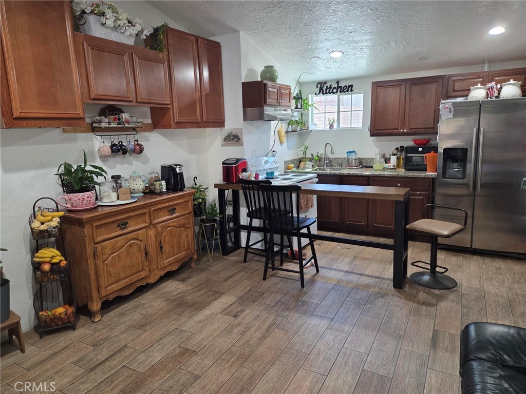 9555 1/2 Hierba Road Agua Dulce, CA 91390 - Photo 6 of 26 a kitchen with granite countertop a refrigerator stove top oven and sink