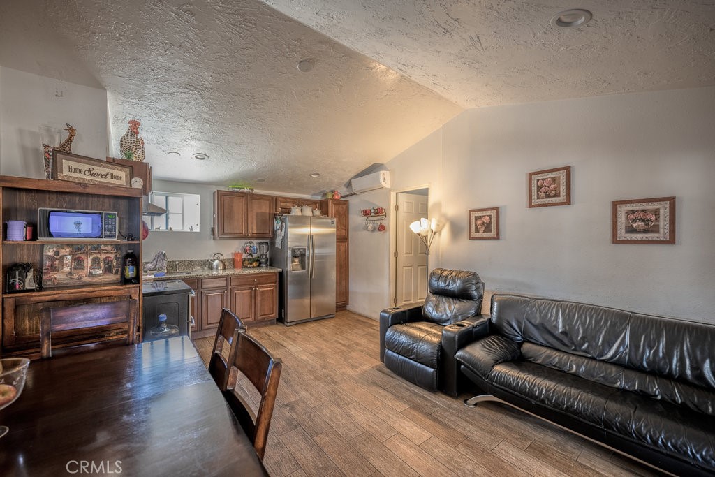 9555 1/2 Hierba Road Agua Dulce, CA 91390 - Photo 7 of 26 a living room with stainless steel appliances furniture a rug and a kitchen view