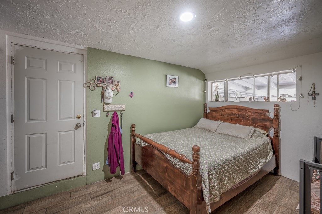 9555 1/2 Hierba Road Agua Dulce, CA 91390 - Photo 9 of 26 a bedroom with a bed and a window