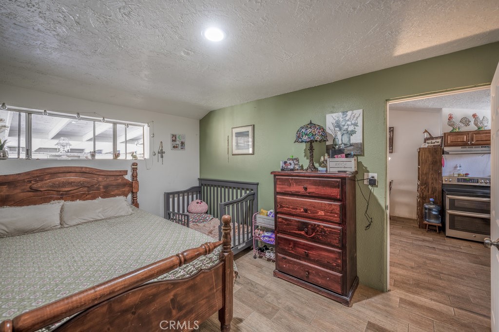 9555 1/2 Hierba Road Agua Dulce, CA 91390 - Photo 10 of 26 a living room with furniture and wooden floor
