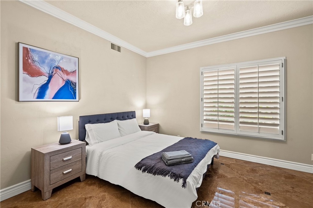 25 Vía Terracaleta Coto de Caza, CA 92679 - Photo 11 of 23 a bedroom with a bed and a painting on the wall
