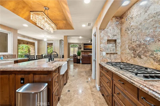 a kitchen with stainless steel appliances granite countertop a stove a sink and a refrigerator