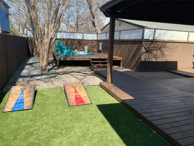 a wooden bench sitting in the middle of a yard