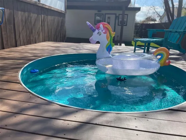 a backyard of a house with table and chairs