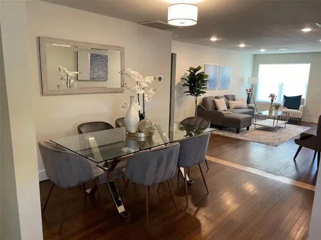 a view of a dining room with furniture and wooden floor