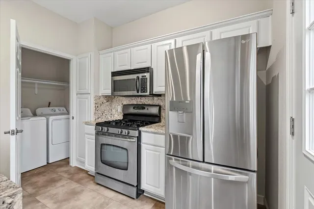 a kitchen with a refrigerator stove and microwave