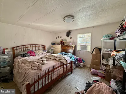 a bedroom with bed and a window