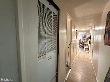 a view of a hallway with wooden floor
