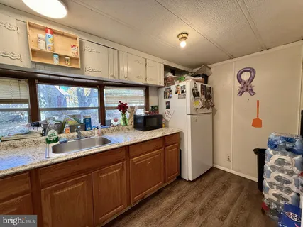 a kitchen with stainless steel appliances granite countertop a refrigerator and sink