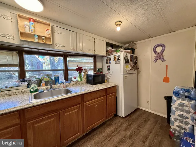 a kitchen with stainless steel appliances granite countertop a refrigerator and sink