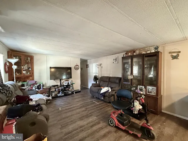 a living room with furniture a window and gym equipment