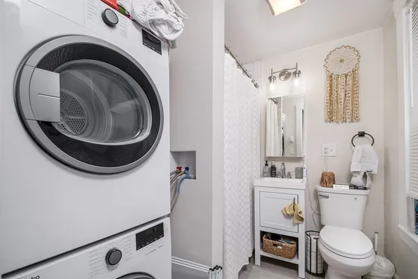 a bathroom with a toilet a sink and a mirror