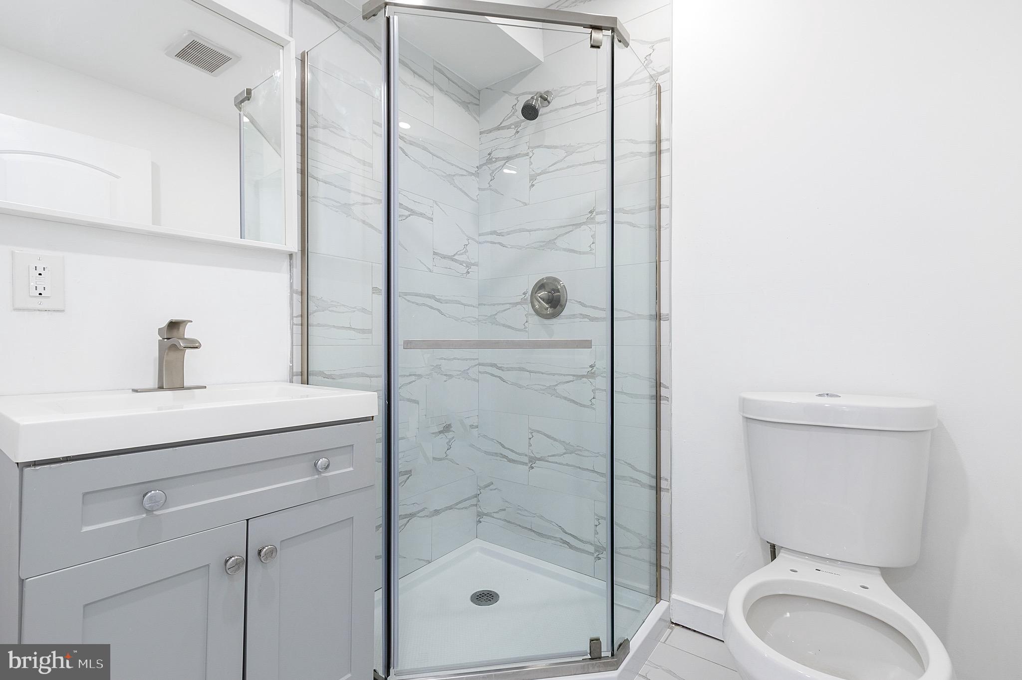 2150 North Franklin Street Philadelphia, PA 19122 - Photo 10 of 24 a bathroom with a shower a sink and mirror