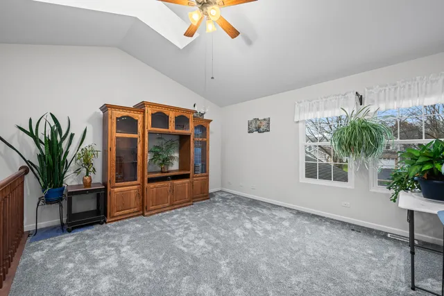 a living room with furniture potted plant and a large window